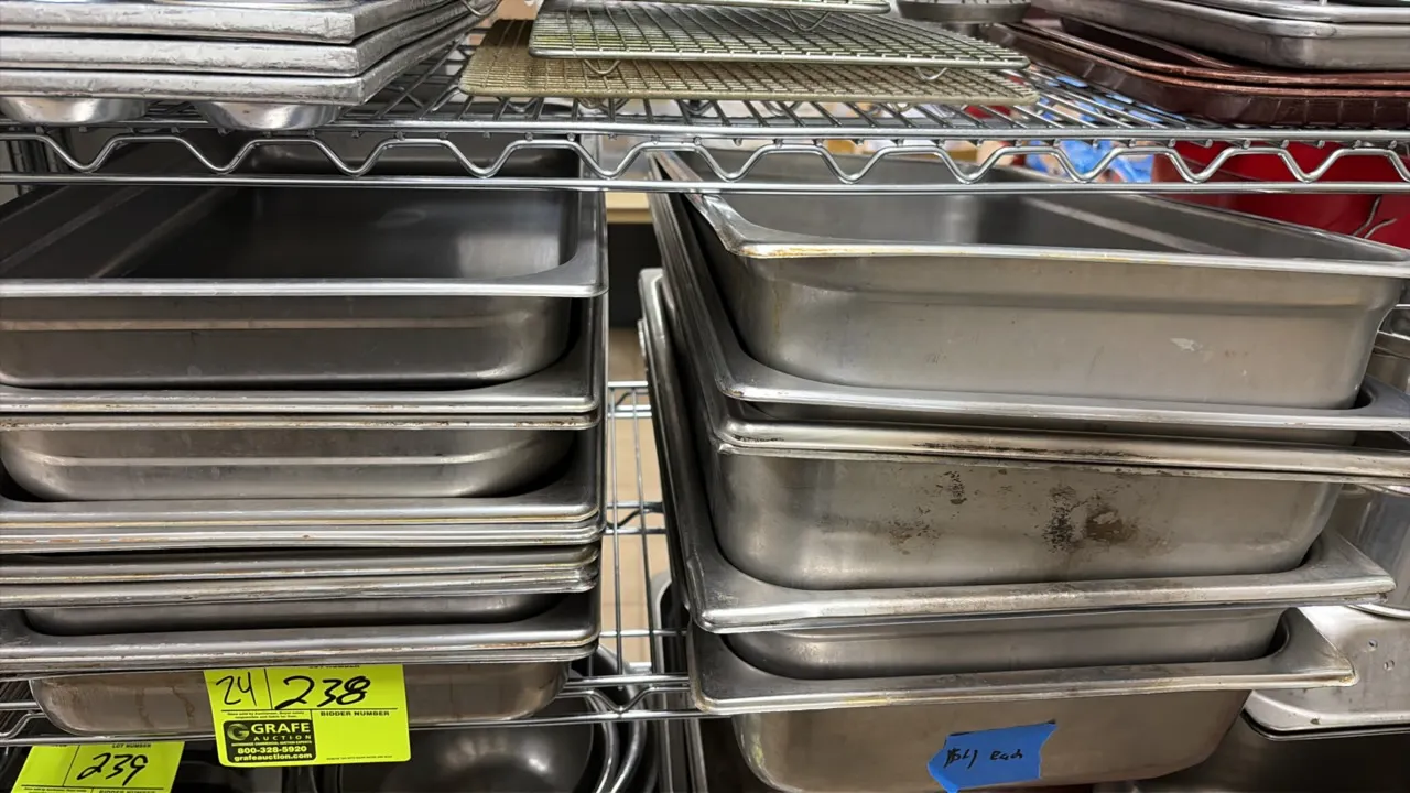 Stainless steel steam table pans. Features full-size hotel pans in assorted depths. Wire shelving and background items not included.