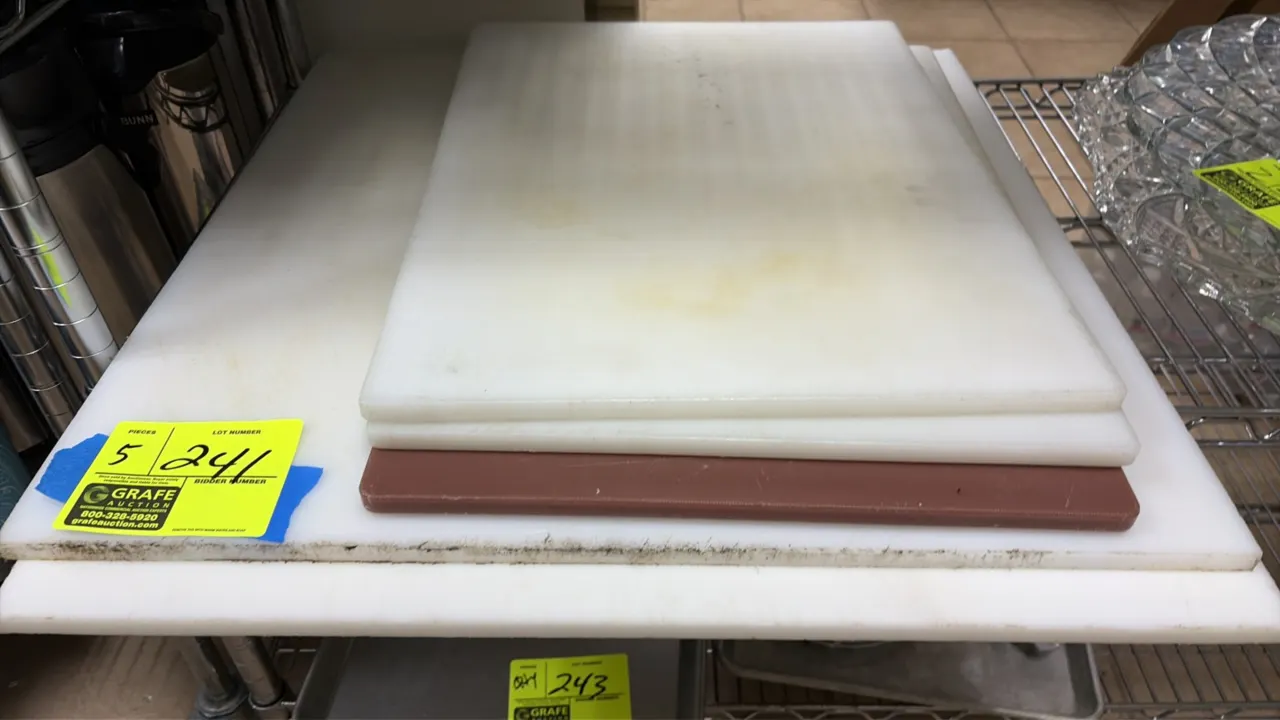 Plastic cutting boards. Features high-density polyethylene construction in assorted rectangular sizes. Includes white and brown boards.