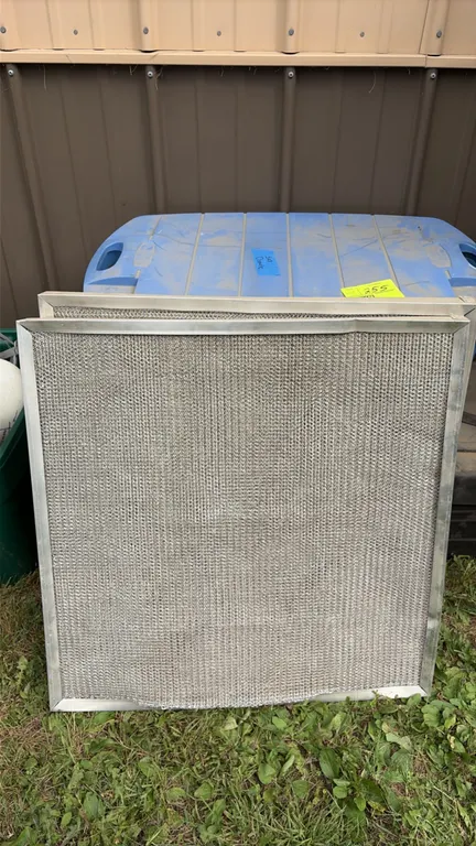 Package lot including metal mesh filters and a plastic storage tote containing commercial ceiling speakers with round grilles and mounting back cans.