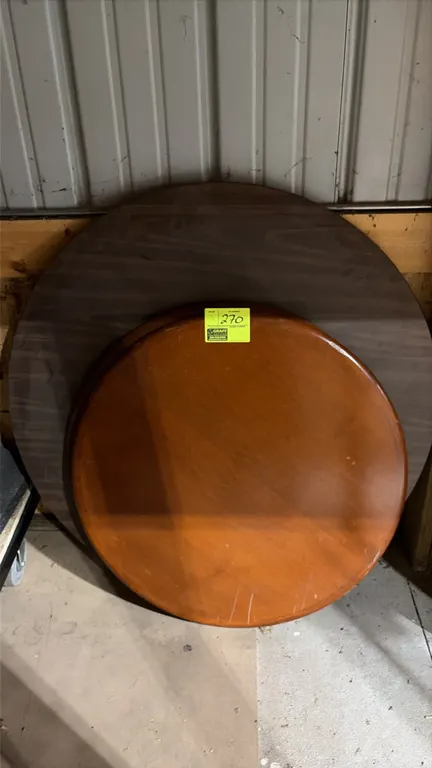 Round wood laminate table tops. Includes (1) 32" diameter top with bullnose edge and warm wood finish, and (1) 42" diameter top with dark woodgrain la