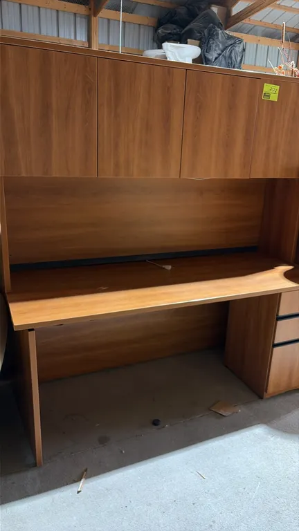 Wood laminate desk with hutch. Features a four-door overhead storage cabinet, right-hand drawer pedestal, modesty panel, and integrated under-cabinet
