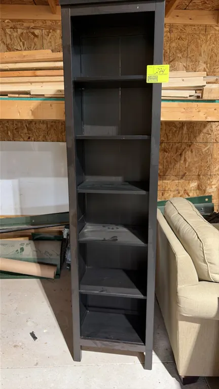 Laminate wood bookshelf. Features a black finish with 6 tiers of shelving and raised block feet.