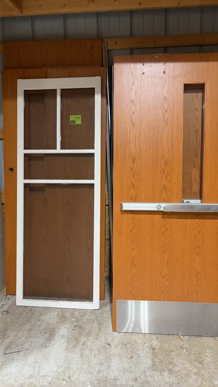 Assorted wood doors. Includes a commercial wood door with narrow vision lite, panic push bar, and stainless steel kick plate, flush wood doors, and a