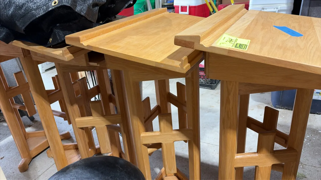 Wood podiums. Features solid wood construction with an oak finish, slanted reading surface with retaining book ledge, and pedestal base with cutout cr