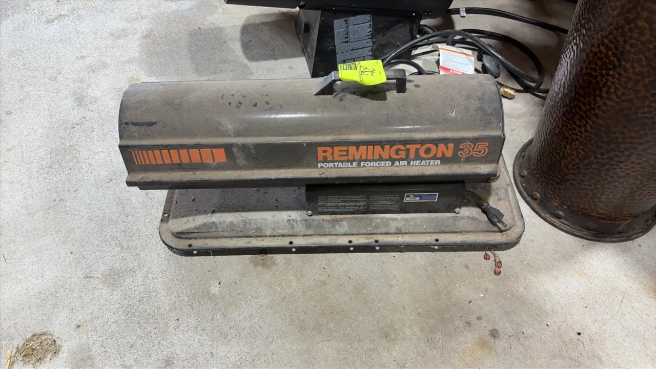 Remington 35 portable forced air heater. Features a top carrying handle, integrated fuel tank base, and attached power cord.
