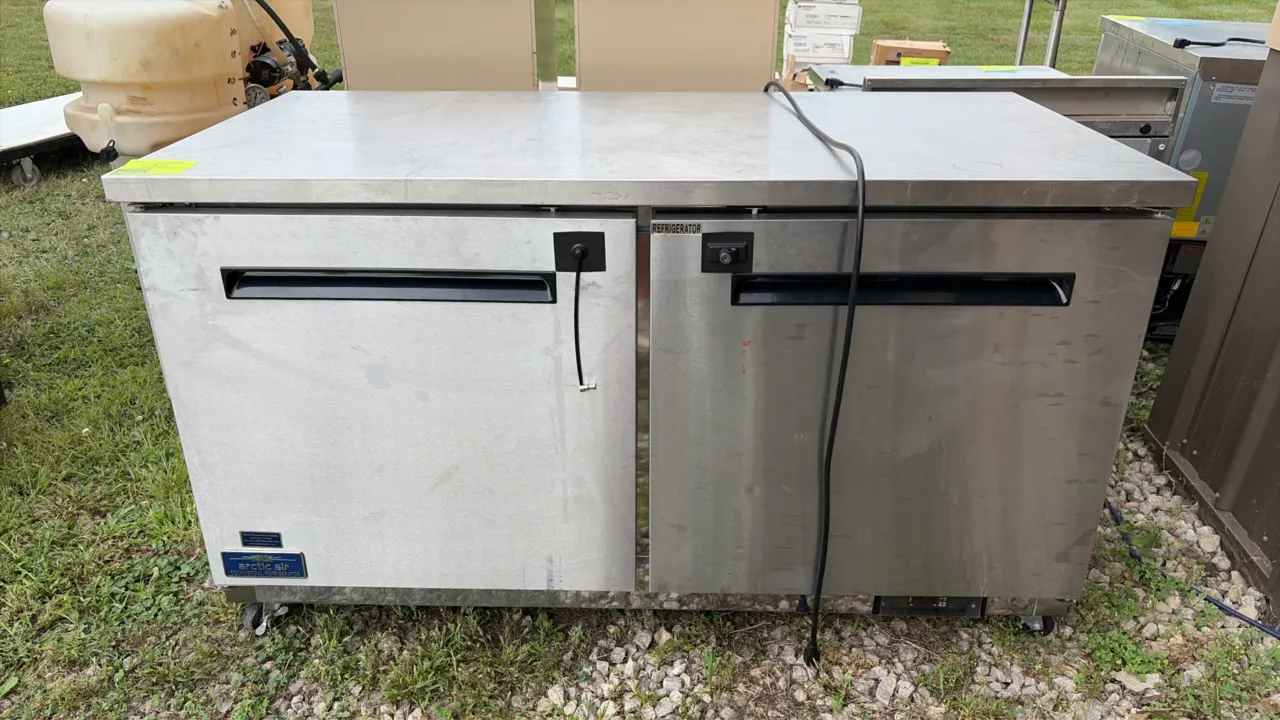Arctic Air AUC60RZ 2-door commercial undercounter refrigerator. Features stainless steel construction, solid doors with recessed handles, and interior