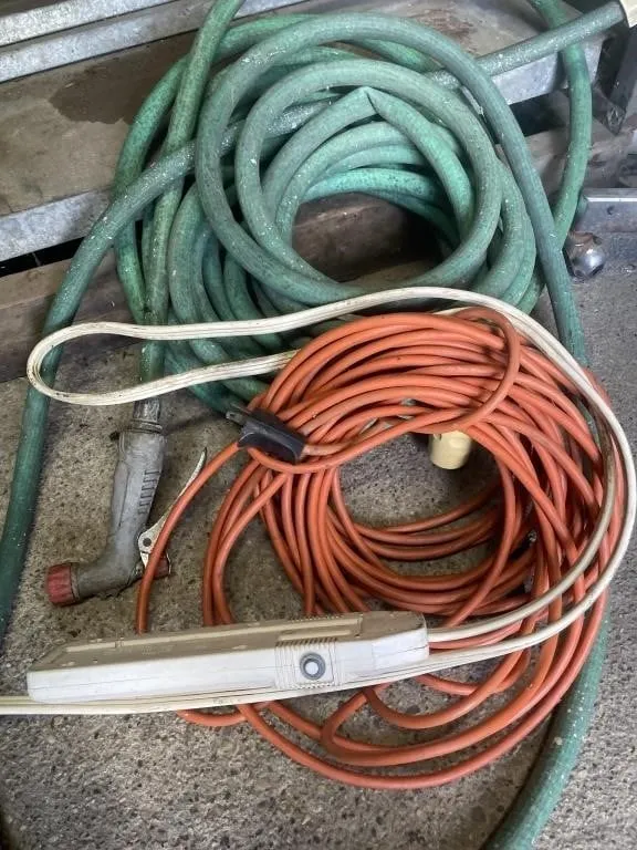Length of garden hose and an extension cord with