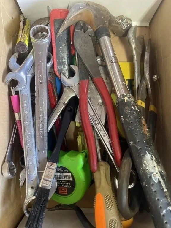 Shoebox full of hand tools.