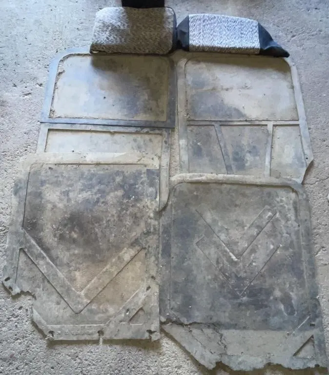Four rubber truck mud flaps, and a seat cushion.