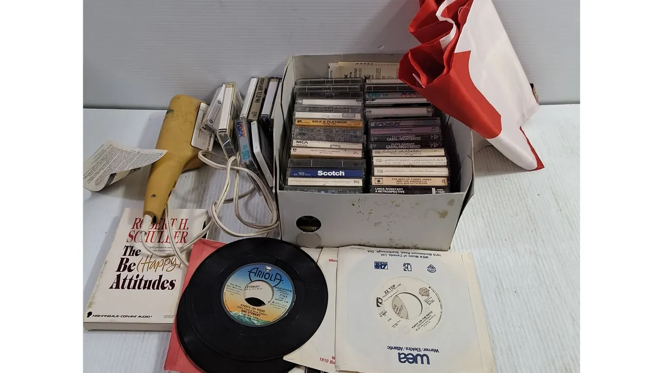 Box of Cassettes and Homemade Recorded Cassettes,(7) 45 Records,Hair Dryer,Audio Book,Canada Flag