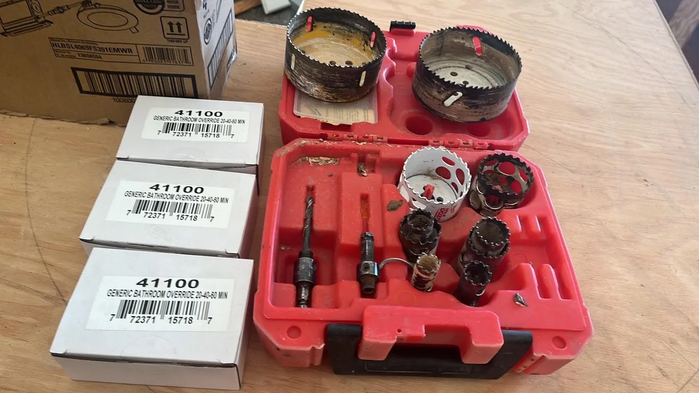 OFFSITE - 11 piece hole saw kit in Milwaukee case. And 3 bathroom fan override switches.