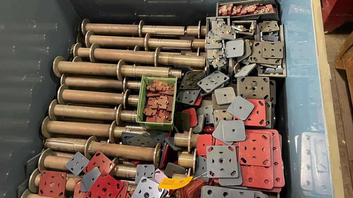 Bin of New Steel Brackets and Rollers