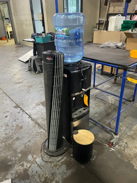 Primo Water Cooler, Space Heater, and Trash Can
