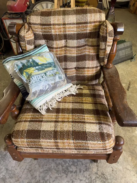 Brown Plaid Upholstered Wooden Armchair and Camper Blanket