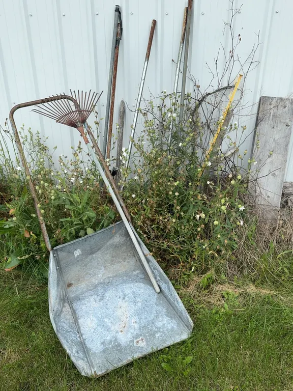 Garden Tools Including Metal Wheelbarrow and Rake