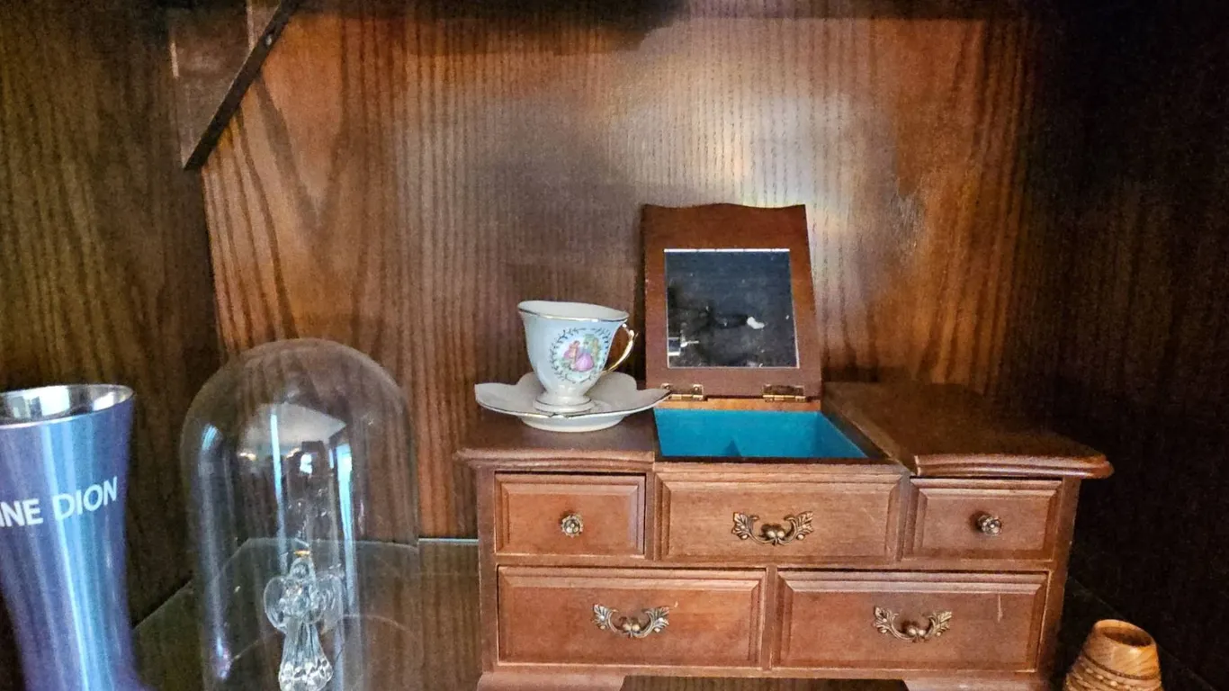 Decorative Collectibles Including Miniature Chest, Glass Angel, and Celine Dion Vase