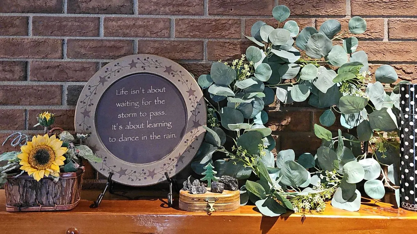 Decorative Plate, Artificial Eucalyptus Wreath, Wooden Chest with Stones, and Sunflower Arrangement