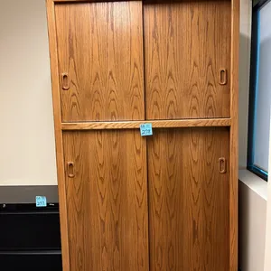 cabinet shelving unit 48”x25”x83”with 4 sliding doors, oak finish