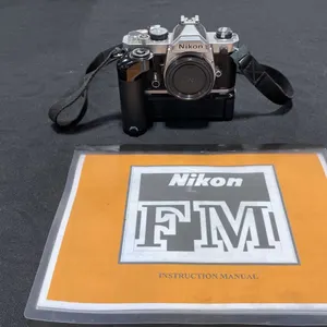 NIKON FM 35MM FILM CAMERA WITH NIKON MD-11 BATTERY POWERED MOTOR DRIVE