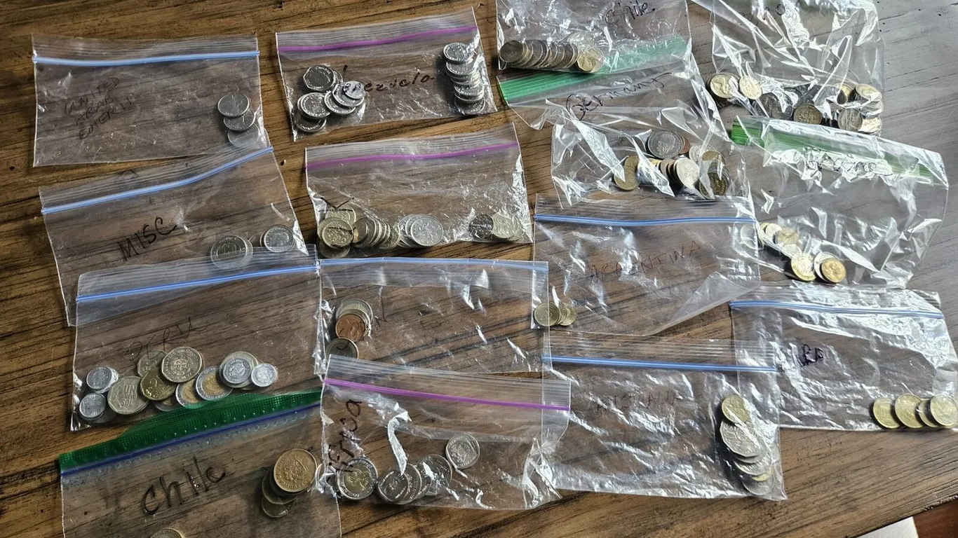 Foreign coin collection in country-labeled bags