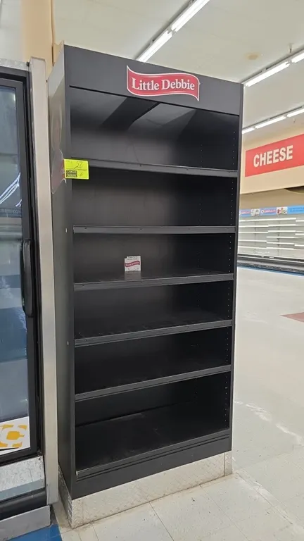 Little Debbie laminate wood display shelving unit. Features black laminate finish, Little Debbie branded header and side graphics, and adjustable shel