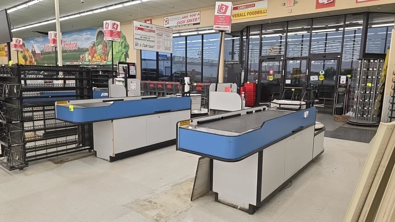 Laminate single-belt checklanes. Features an 8'L motorized belt section, cashier stand with POS and monitor mounts, scanner well cutout, blue accent t