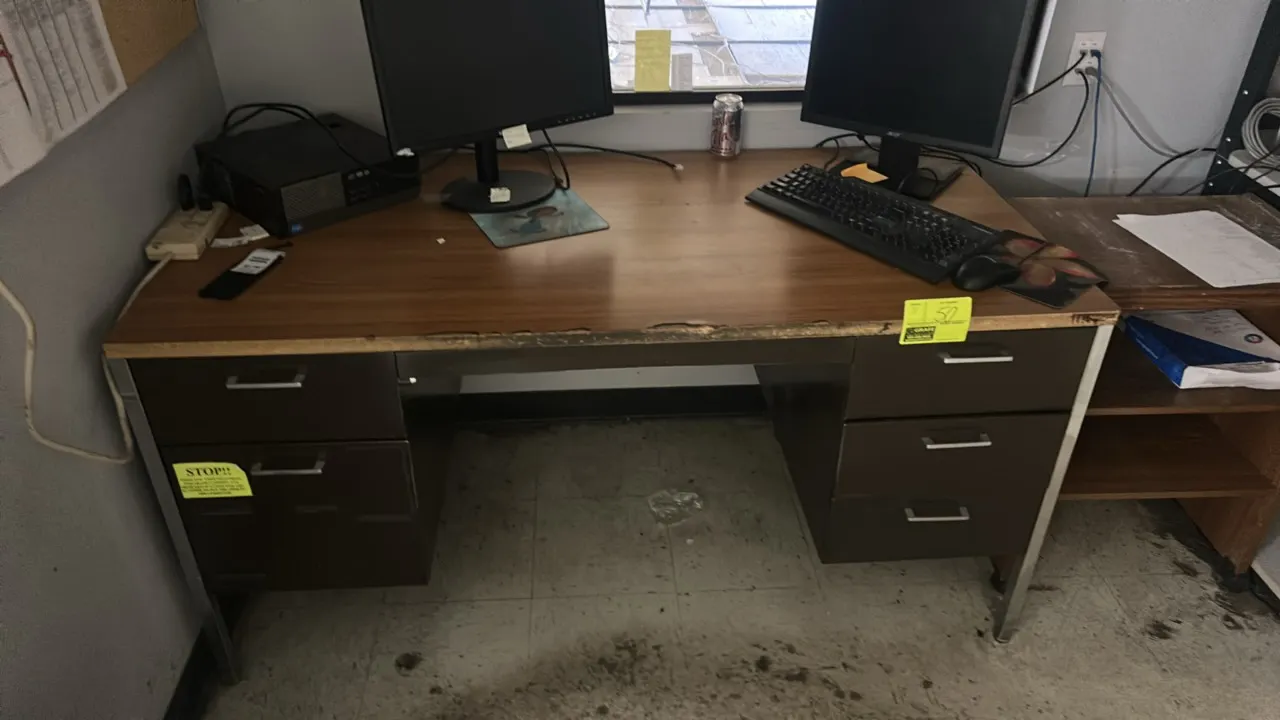 Office furniture lot. Includes 60" x 30" metal desk with laminate top, 3-tier wooden stand, and multi-tier metal rack. Desk features double-pedestal d