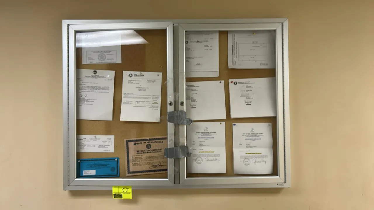 Quartet enclosed cork bulletin board. Features dual hinged lockable doors and an aluminum frame. Dimensions: 4'W x 3'H. Wall mounted. Note: Taped shut