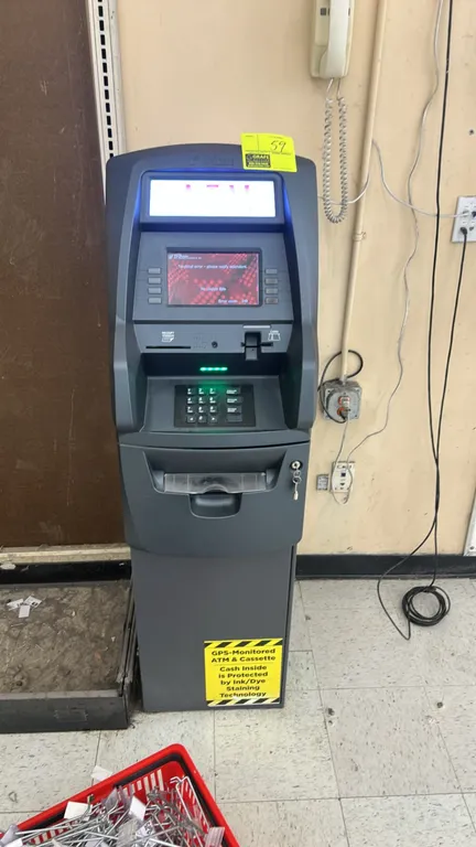 Triton Traverse retail ATM terminal. Features color display screen, numeric keypad, card reader, integrated receipt printer, illuminated topper, and c