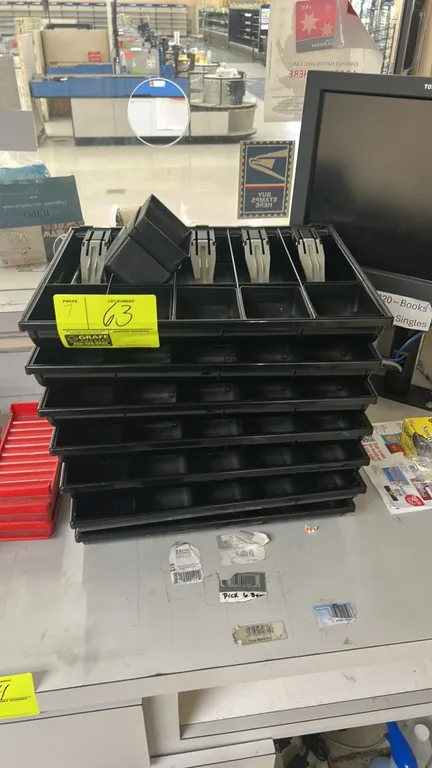 Poly cash drawer till trays. Features molded black plastic construction, bill slots with spring-loaded clips, and divided coin compartments. POS monit