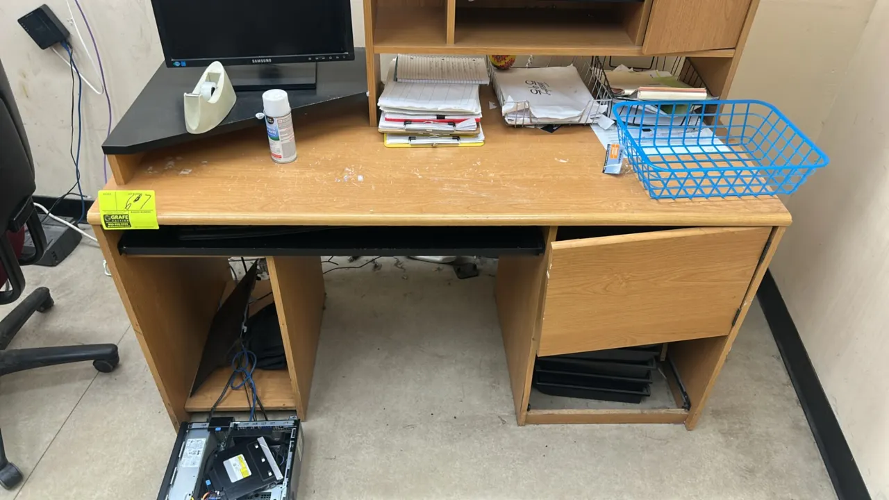 Laminate computer desk with hutch. Features upper organizer shelving, corner monitor riser, slide-out keyboard tray, and lower storage compartments. 5