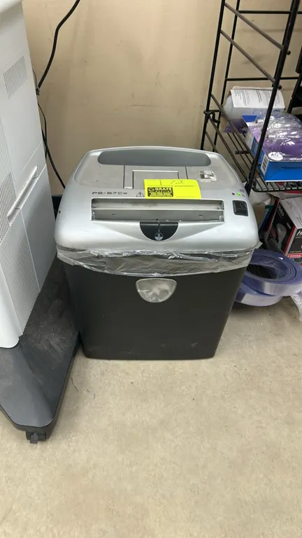 Fellowes PS-67Cs cross-cut paper shredder. Features integrated waste bin with viewing window, top carry handle, and electronic controls.