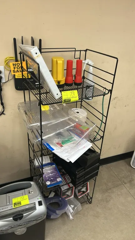 Multi-tier metal wire rack with contents. Includes flashlights, Halco 250W light bulbs, clear poly organizers, plastic letter trays, vinyl strip curta