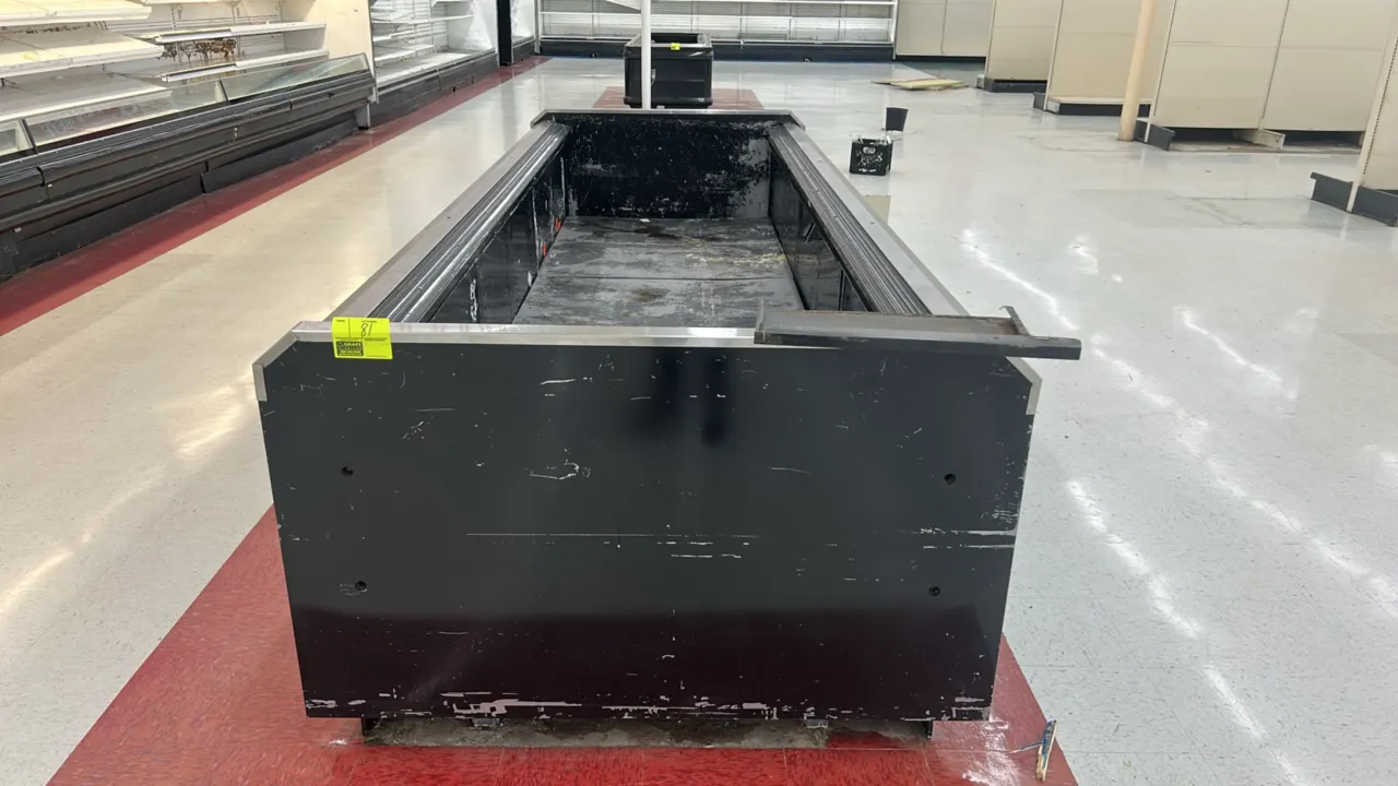 Hussmann self-contained wide island display case. Features an open-top merchandiser design, black exterior finish, and stainless steel top rail and bu