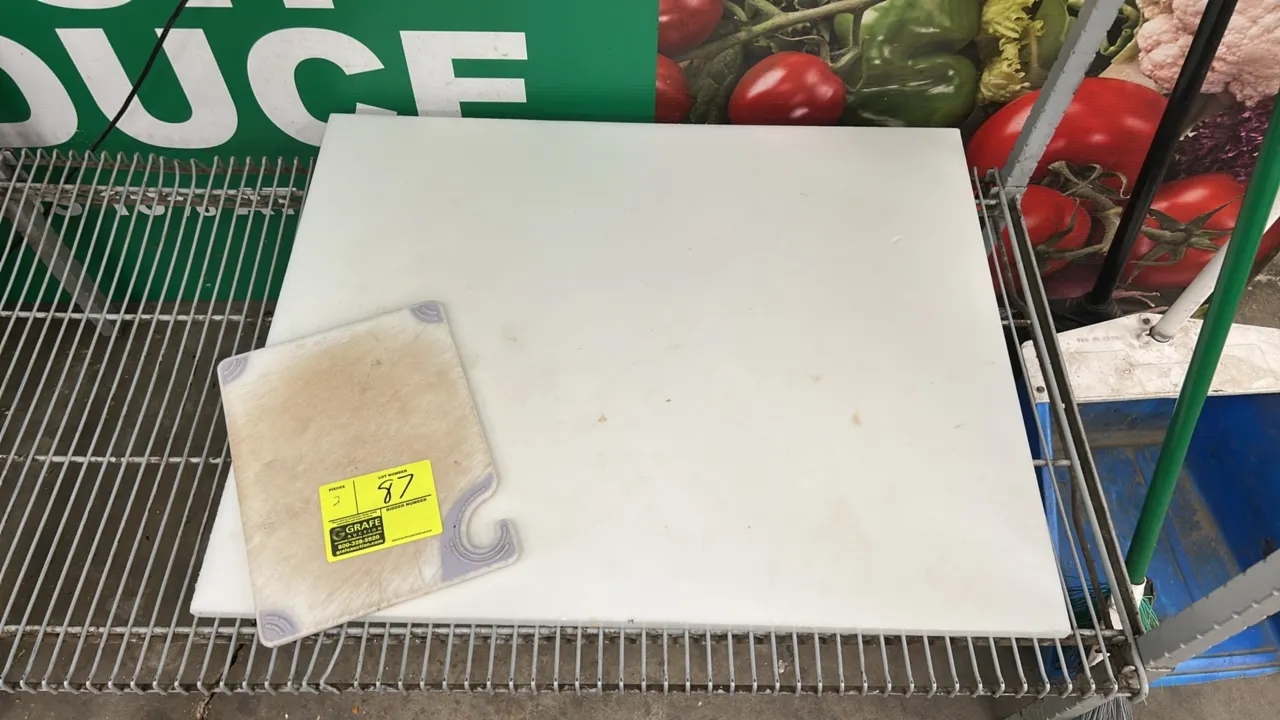 Poly cutting boards. Includes (1) 24" x 32" white poly board and (1) 12" board featuring non-slip corner grips and an integrated hanging hook.