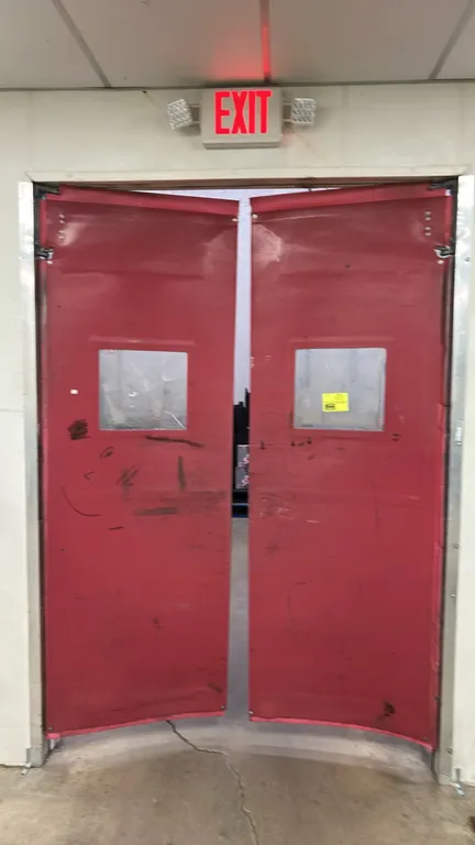 Poly swing doors. Features red flexible construction with clear vision panels and top mounting swing brackets. Dimensions: 32"W x 96"H each.