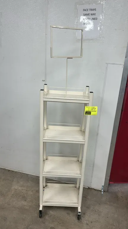 Metal 4-tier portable merchandiser rack. Features white metal frame construction, 4 shelves with retaining wire rails, and an attached top sign holder