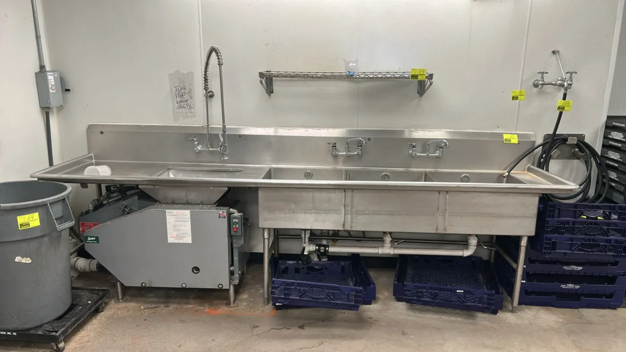 Stainless steel 3-compartment sink with left drainboard and Garb-el food waste disposal system. Features (3) sink basins with lever waste valves, pre-