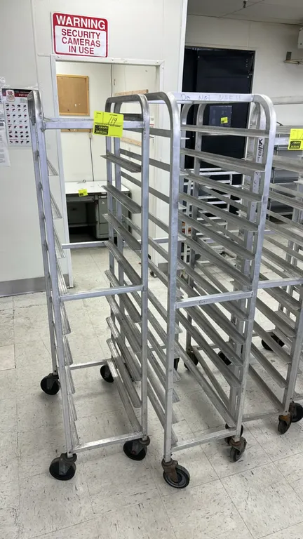 Aluminum front-load meat platter racks. Features welded aluminum construction with angle slide runners. Mounted on swivel casters.