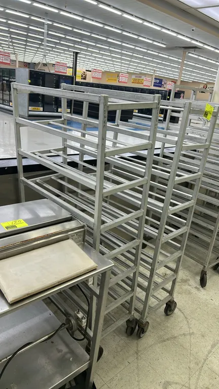 Aluminum front-load meat platter racks. Features welded aluminum construction with multi-tier angle slide runners. Mounted on swivel casters.
