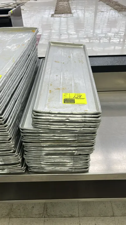 Full-size aluminum meat platters. Features aluminum construction with ribbed bottoms and raised edges. Stainless steel table not included.