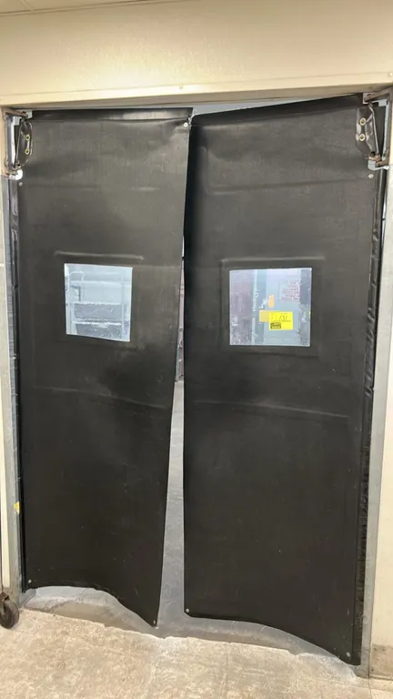 Poly swing doors. Features black flexible construction, clear square vision panels, and top swing hinge mounting hardware. Dimensions: 32"W x 96"H eac
