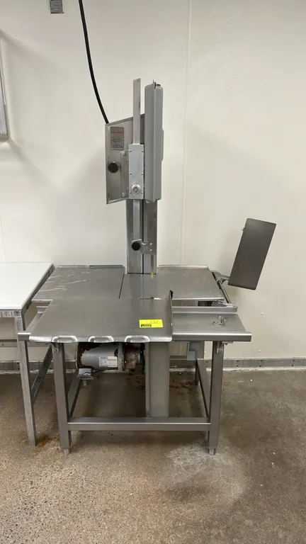 Hobart 5801 commercial meat saw. Features a stainless steel sliding carriage, stationary cutting table, adjustable blade guard, and thickness gauge pl