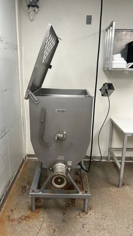 Hobart 4346 commercial mixer grinder. Features stainless steel construction, hinged perforated hopper lid, interior mixing paddle, feed auger, and mou