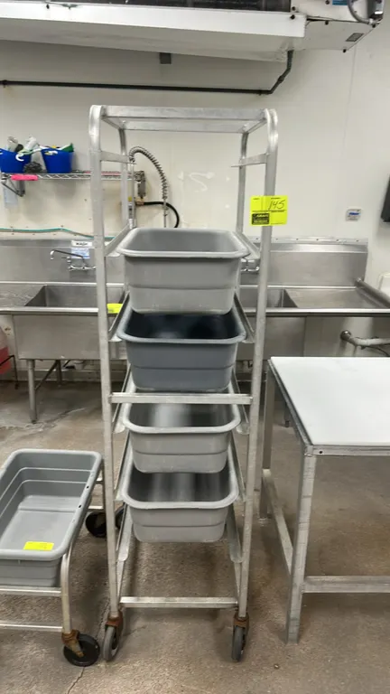 Aluminum bus tub rack. Features 4-tier slide construction. Includes (4) 26" poly bus tubs. Mounted on swivel casters.