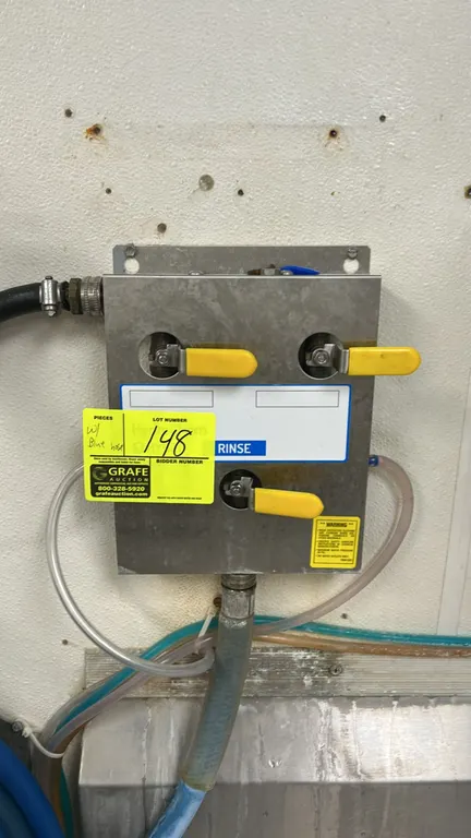 Hydro Systems stainless steel chemical dispenser. Features 3-valve operation with lever handles, chemical intake tubing, blue washdown hose, and stain
