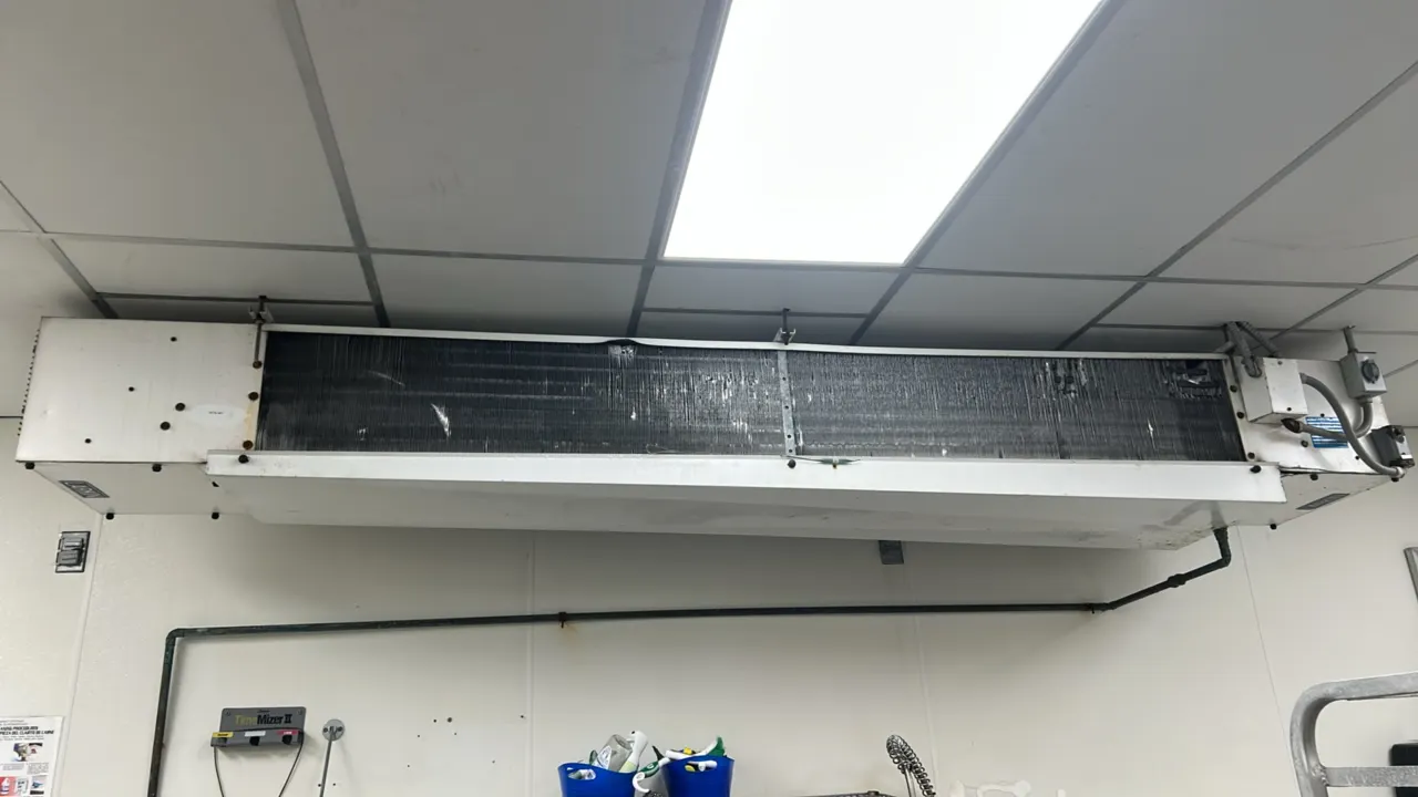 Larkin commercial refrigeration evaporator coil. Features ceiling-mount configuration, finned coil assembly, and integrated bottom drain pan.
