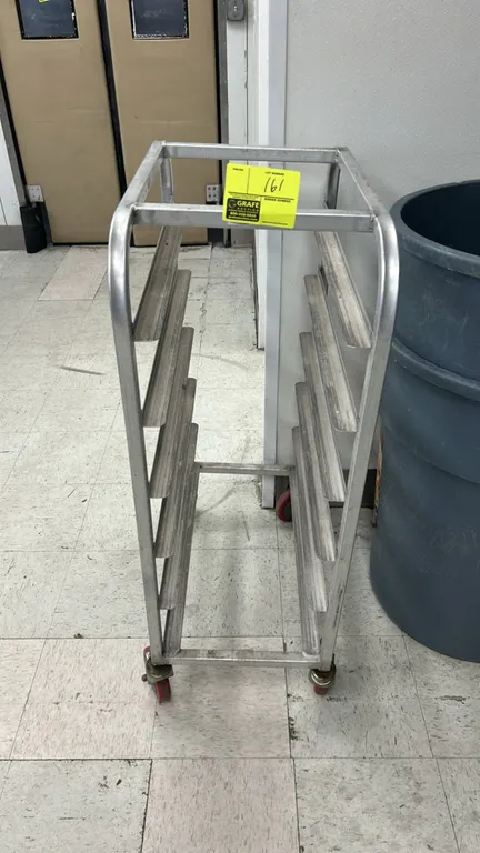 Half-size aluminum meat platter rack. Features 6-tier platter slides. Mounted on swivel casters. Background items not included.
