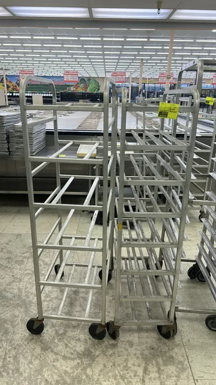 Full-size aluminum meat platter racks. Features welded aluminum construction with multi-tier platter runners. Mounted on swivel casters.