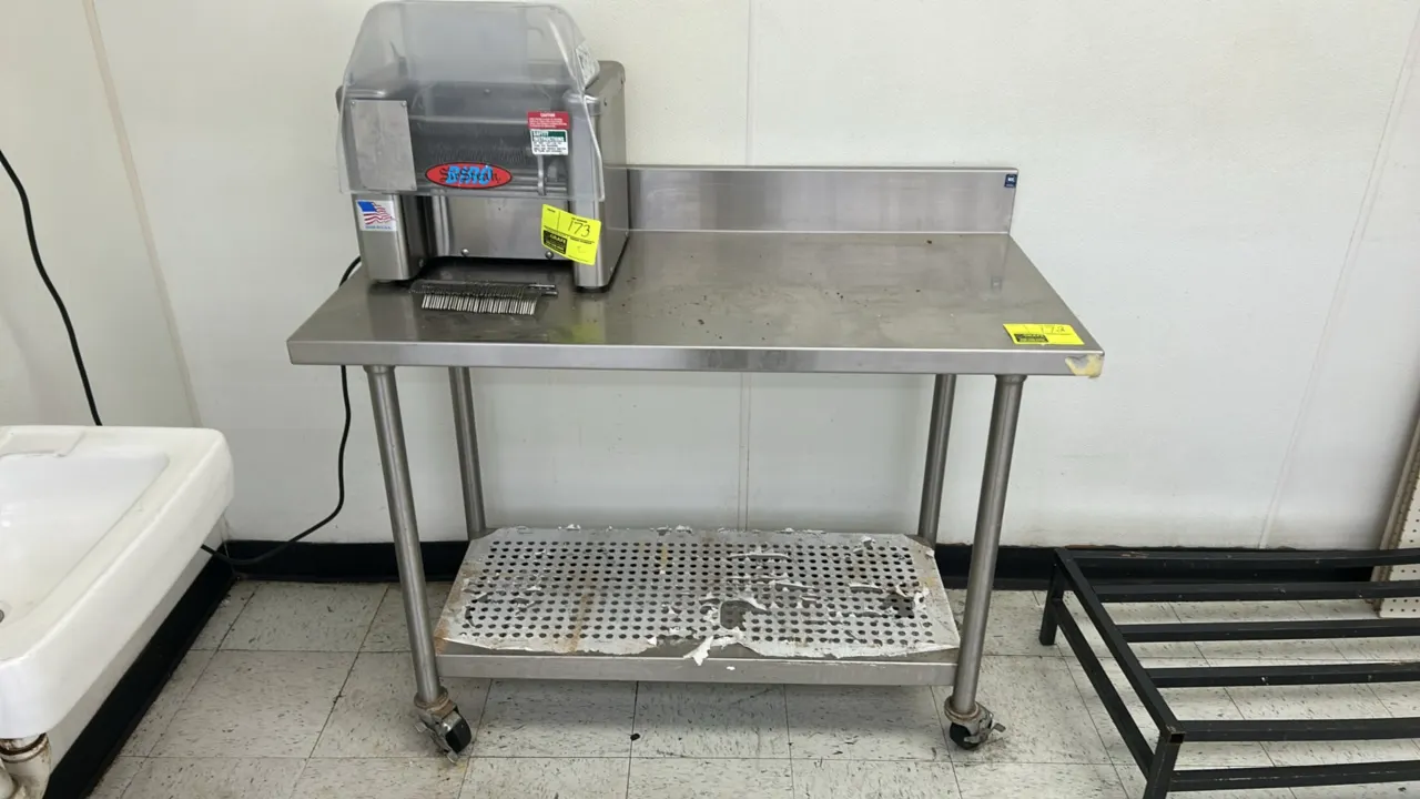 Stainless steel portable work table. Features a rear backsplash, perforated undershelf, and stainless steel tubular legs. 4' x 2'. Mounted on swivel c